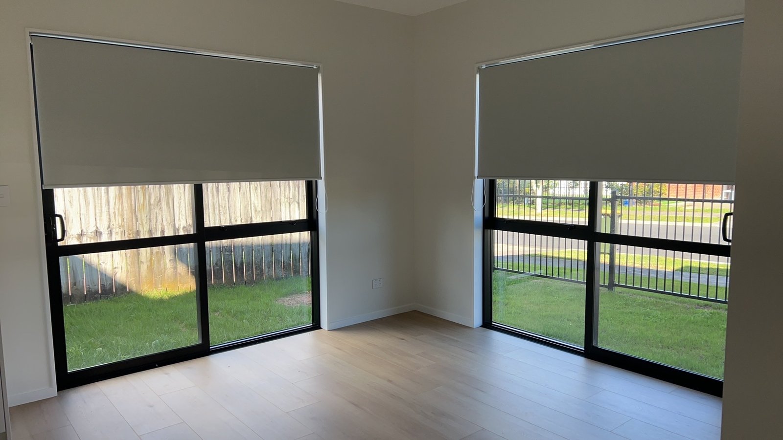 Grey roller blinds on glass doors