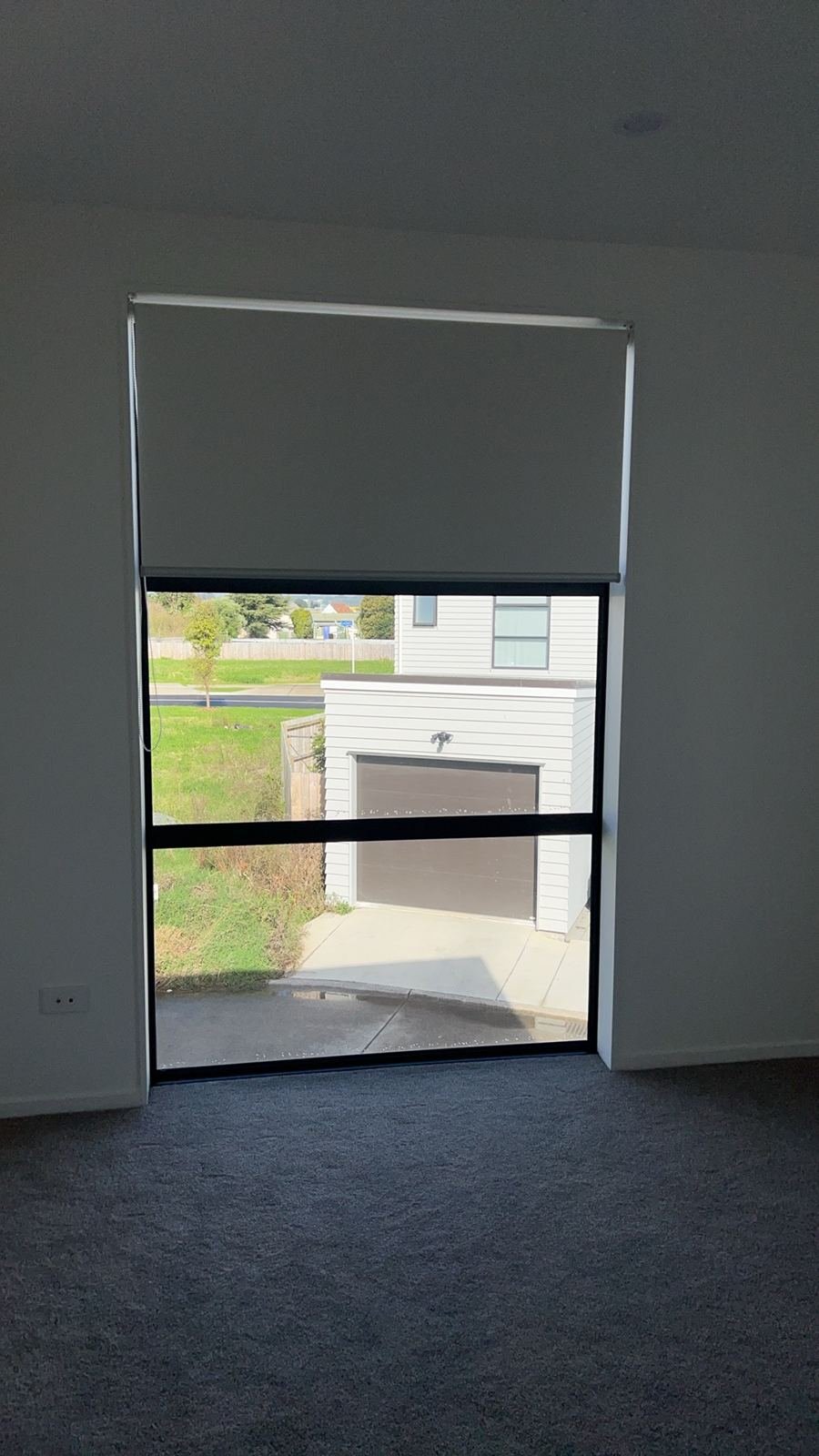 Roller blind half drawn with street view