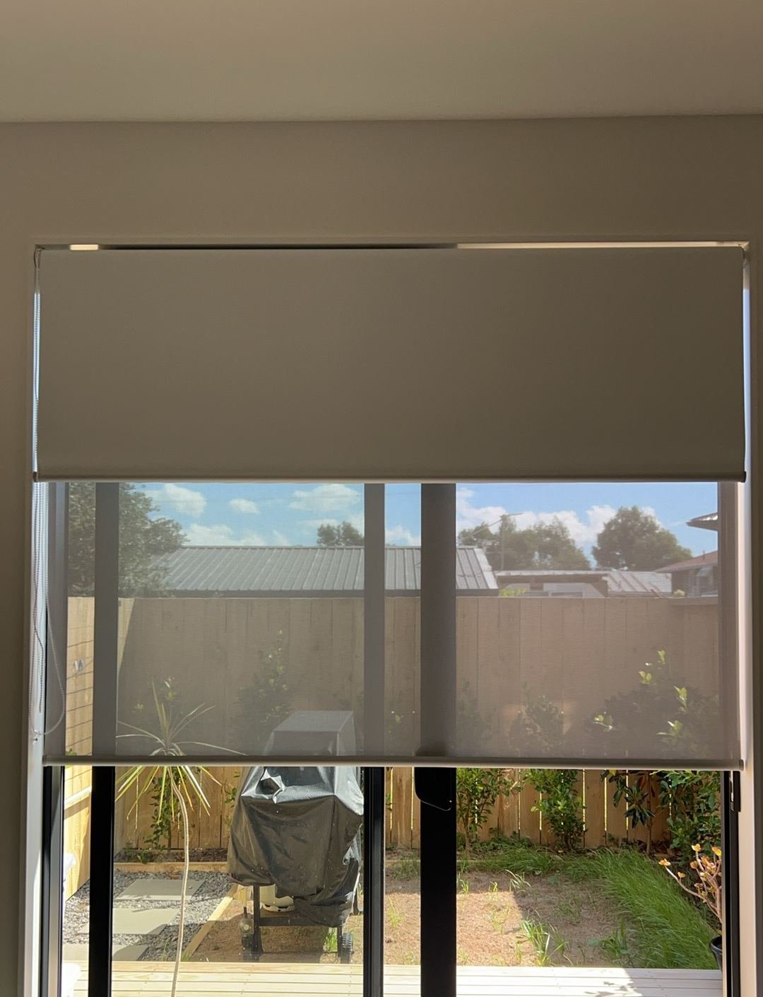 Day-night double roller blinds with backyard view